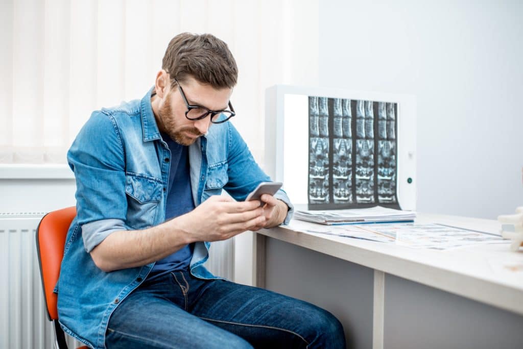 Man sitting hunched down in the office of therapist